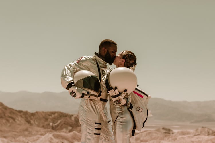 An Astronaut Couple Kissing Each Other