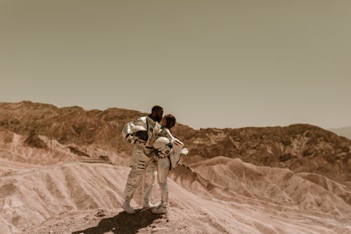 Man and Woman in Astronaut Costume Kissing 
