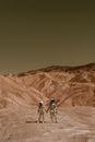 Astronauts Holding Hands on a Desolate Planet