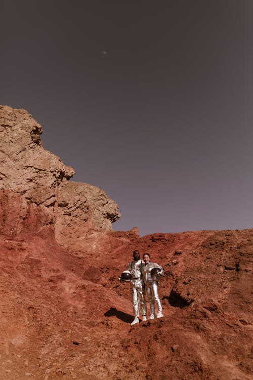 Free Astronauts Standing on Dry Rocky Land Stock Photo