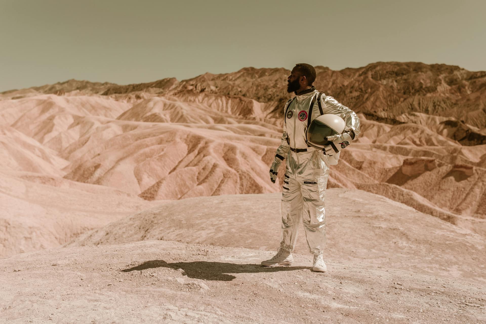 A Male Astronaut Standing in a Desolate Area