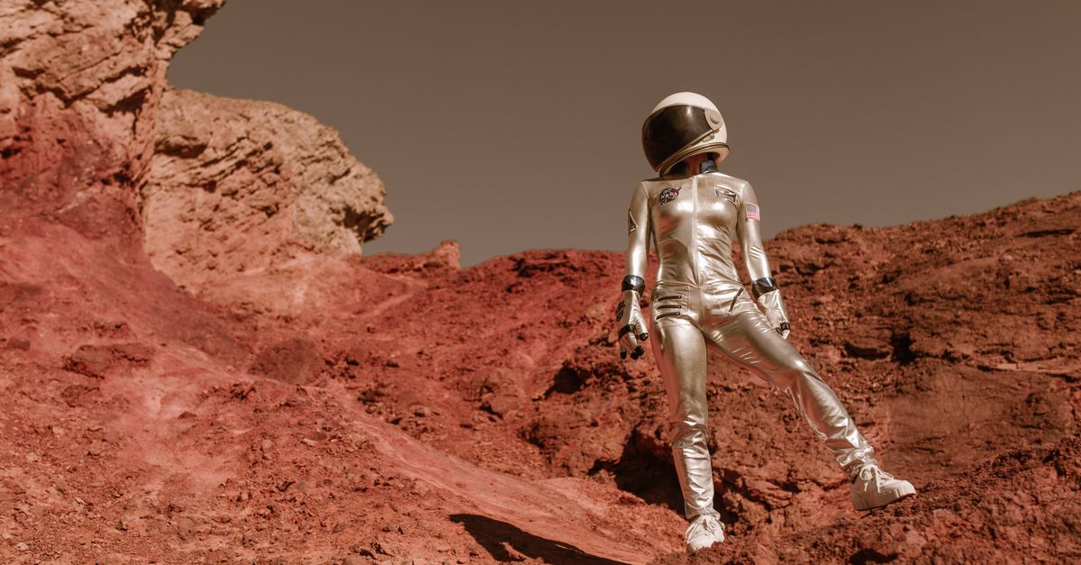 A crew of four in futuristic space suits standing on a red, rocky Martian surface with a small inflatable habitat in the background