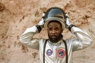 An Astronaut Putting on his Helmet