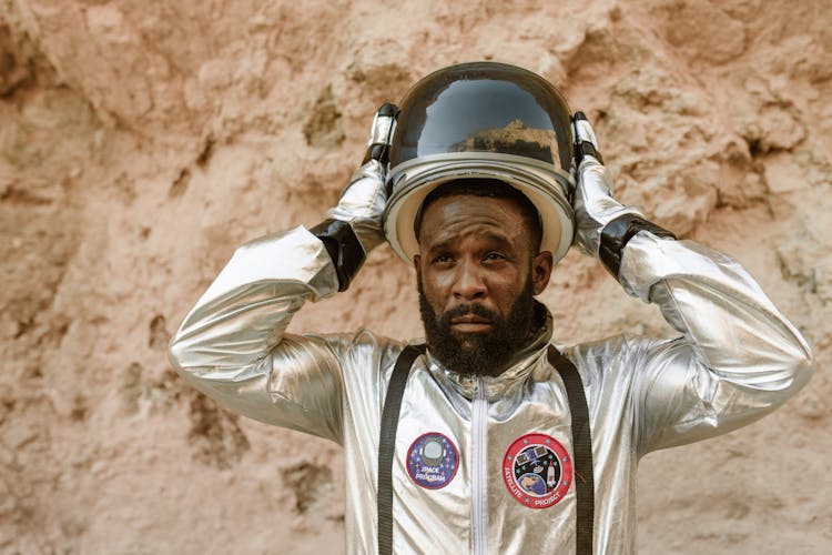 An Astronaut Putting On His Helmet