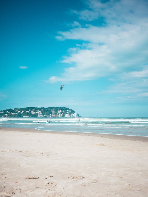 A Person Kite Surfing at a Scenic Beach