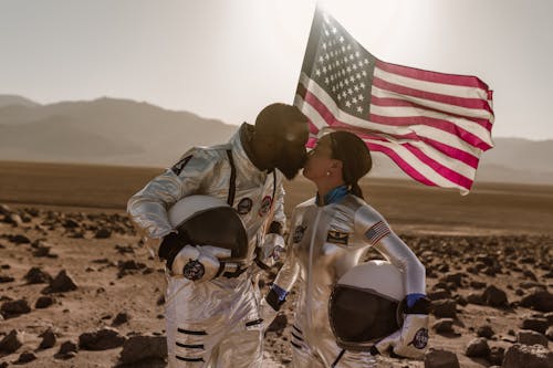 A Couple in Space Suits Kissing
