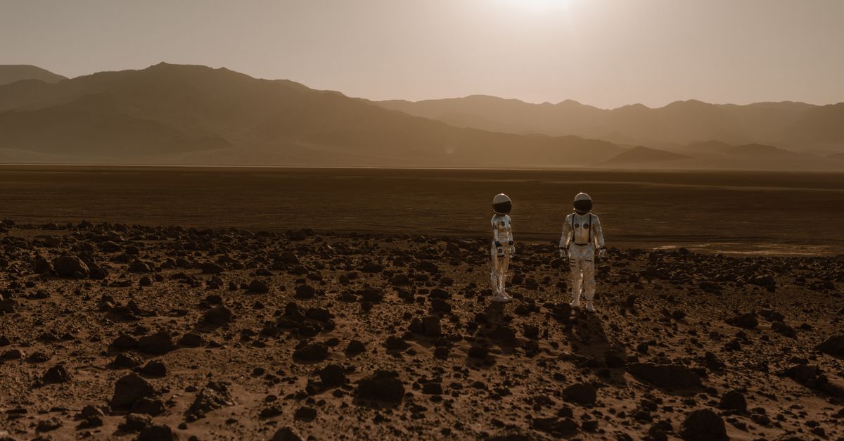 A sleek futuristic Mars lander on a launchpad at twilight, with engineers in white suits around it