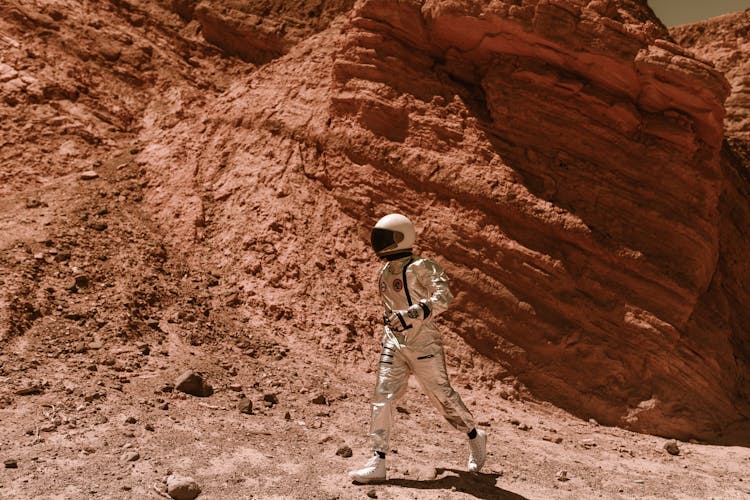 Astronaut Walking Near A Rock Formation 