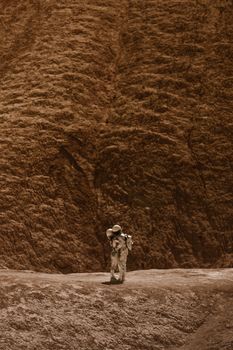 A couple of astronauts embracing on a barren, Mars-like terrain, evoking romance and space exploration.