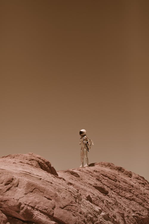 Astronaut in a Spacesuit Standing on Top of a Mountain on Mars 