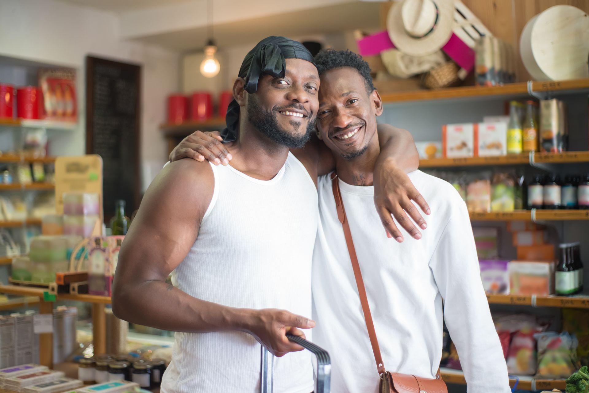 Joyful couple shopping in a local store, smiling with arms around each other.