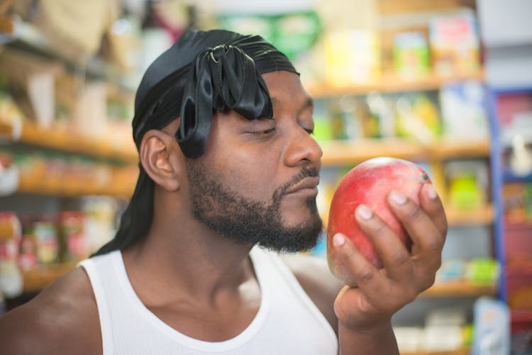 Close-Up Shot Of A Man Holding An Apple