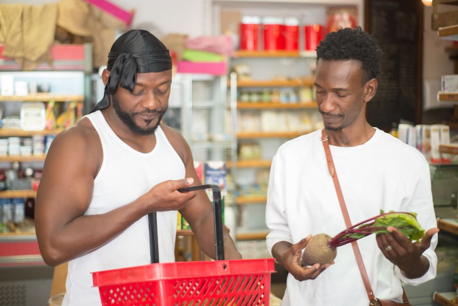 Two men enjoying a grocery shopping experience, selecting fresh produce in a store. Two men enjoying a grocery shopping experience, selecting fresh produce in a store.