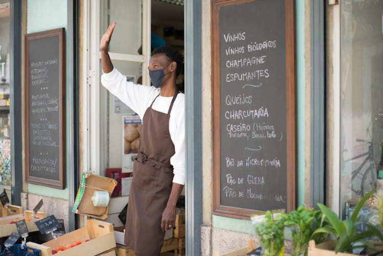 A Happy Store Clerk At A Strore Front