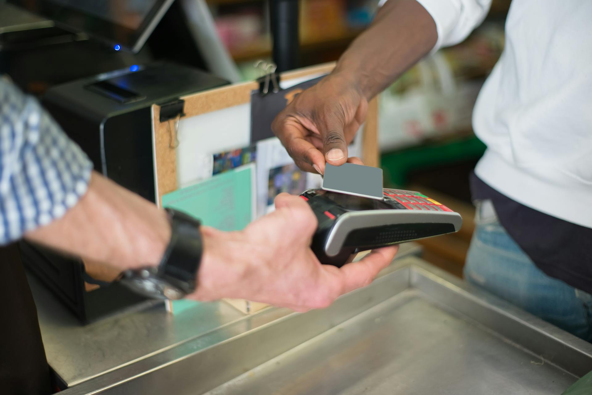 A contactless payment being made using a card reader at a retail store checkout counter.