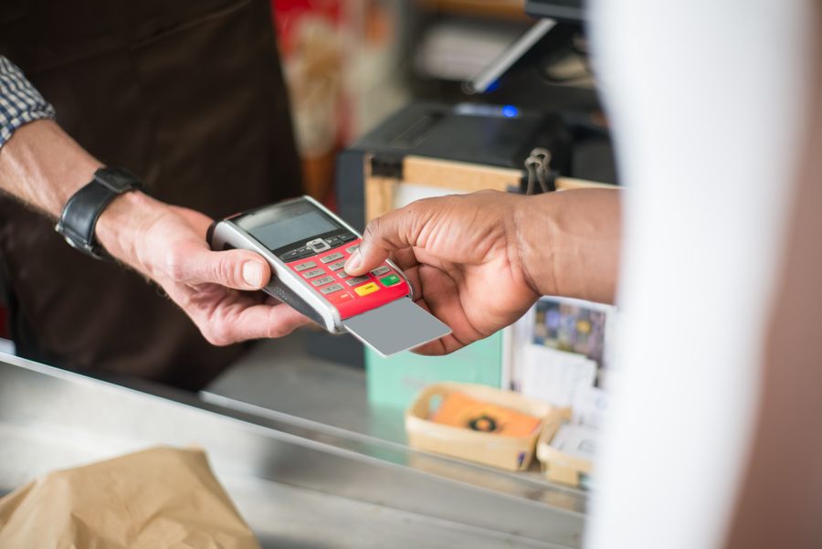 A customer making a contactless payment at a retail checkout