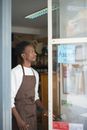 A STore Clerk Standing by the Front Door