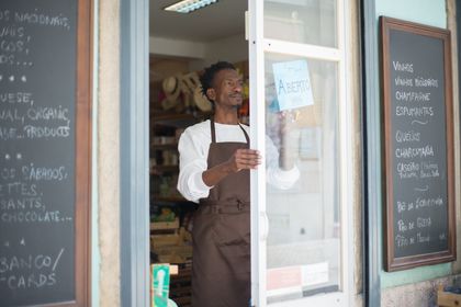 Small business owner behind a shop counter — photo by Kampus Production on Pexels