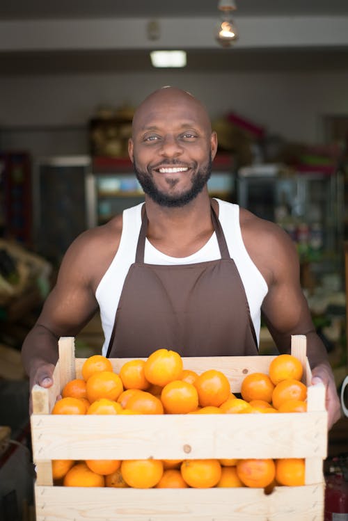 Kostnadsfri bild av afroamerikan, apelsiner, bärande