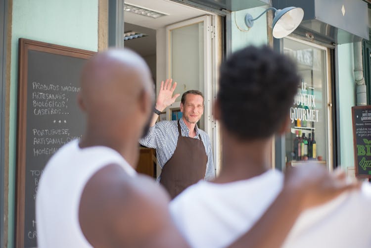 A Store Clerk Waving Goodbye