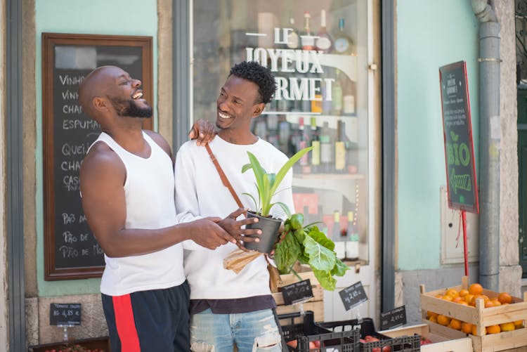 A Male Couple Laughing Together