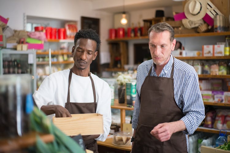 Men Organizing The Products In A Grocery