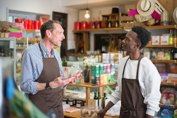 Men Talking Inside A Grocery Store