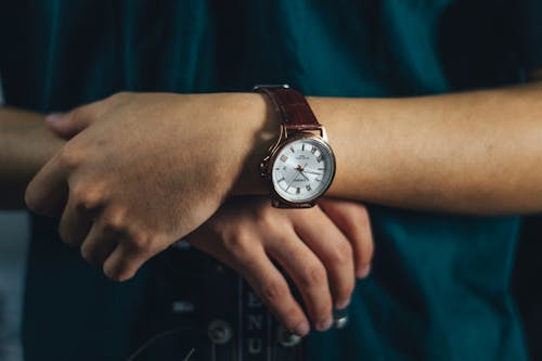 Person Wearing a Wristwatch with a Leather Strap