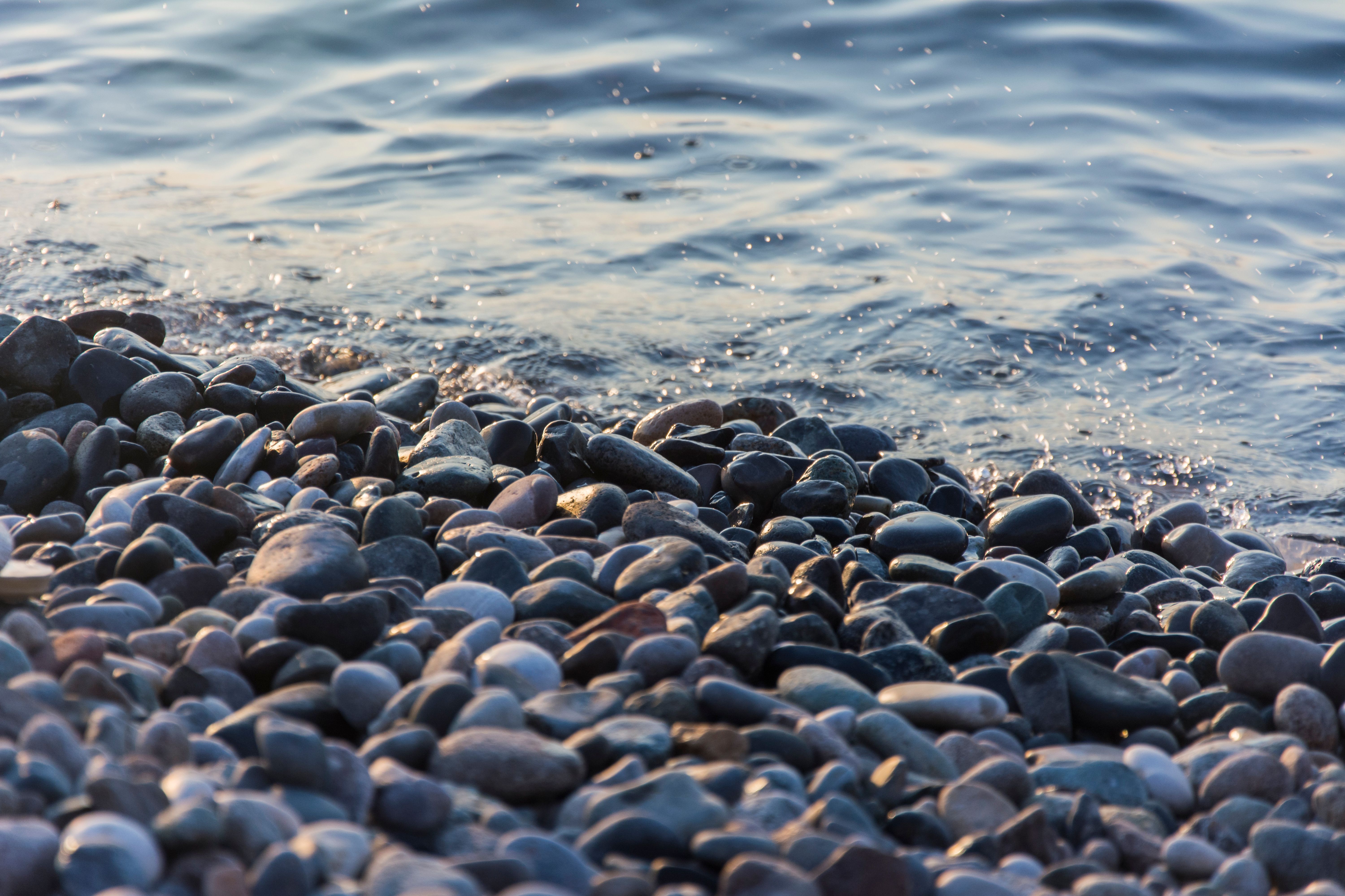 Water shoes on a pebble beach along the Bay of Kotor, Montenegro.