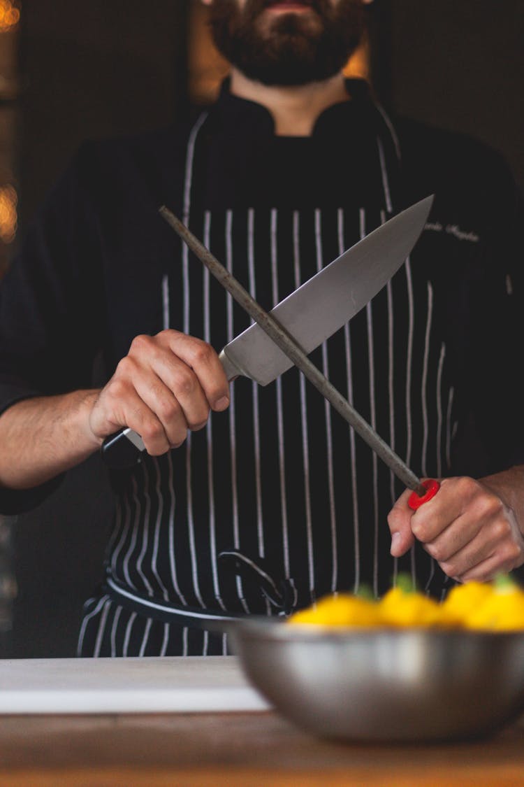 A Chef Sharpening A Knife