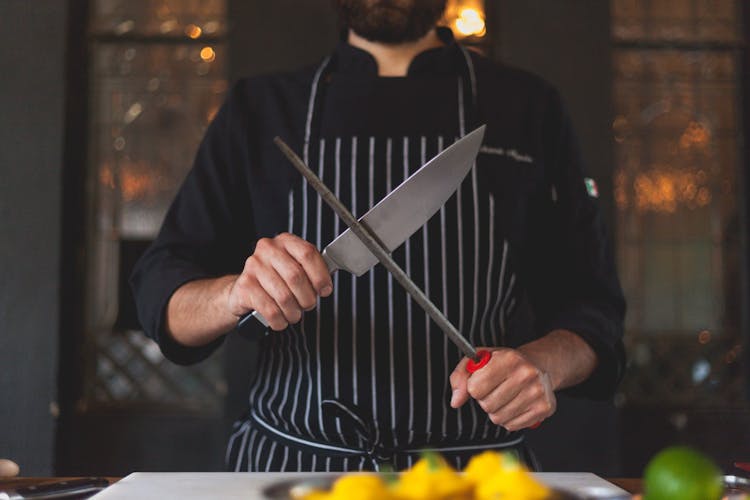 Man Sharpening A Knife