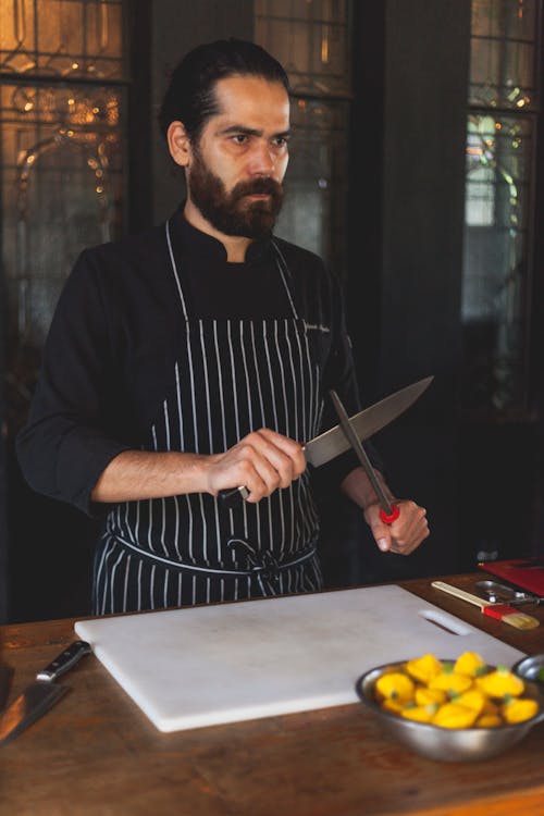 Free Chef Sharpening a Knife Stock Photo