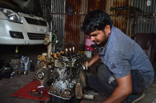 Mechanic Fixing an Engine