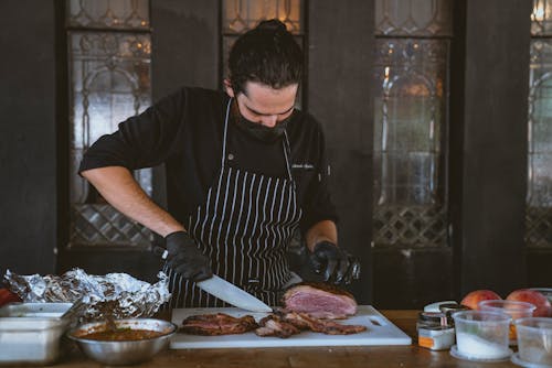 Man Wearing an Apron Cutting a Streak