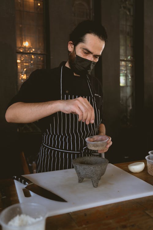 Chef Holding a Cup of Seasoning