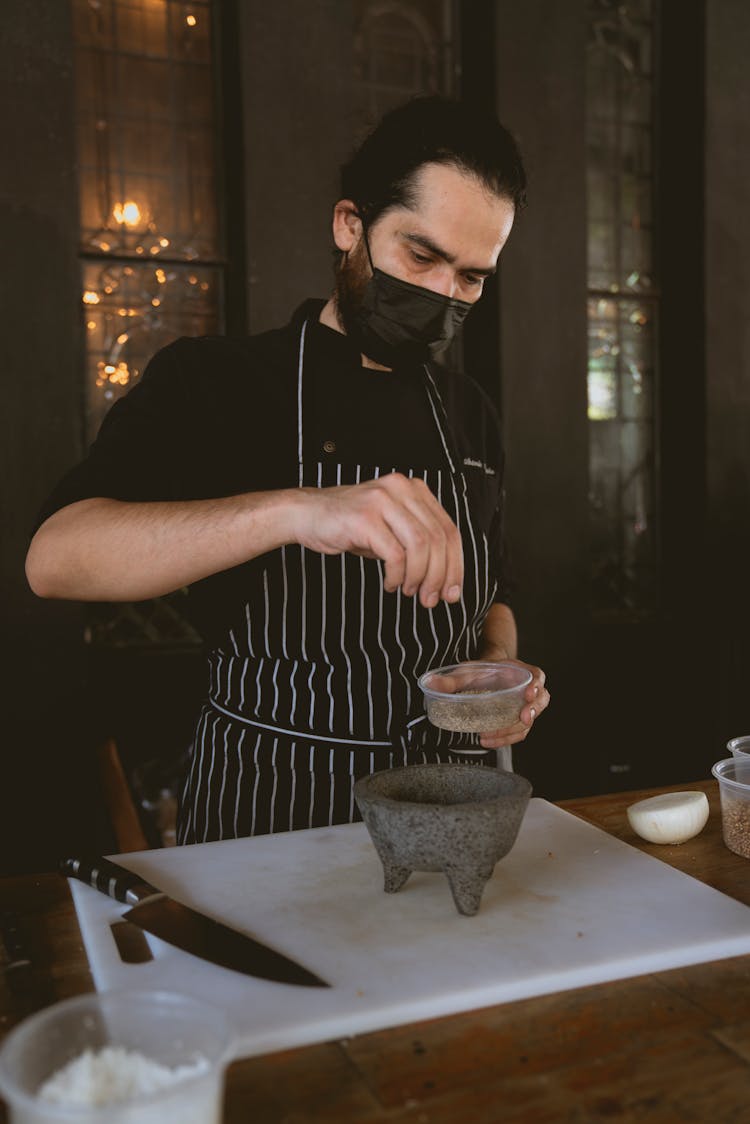 Chef Holding A Cup Of Seasoning