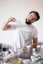 Man Checking the Consistency of the Mixture