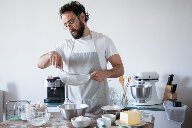 A Man Sifting Flour