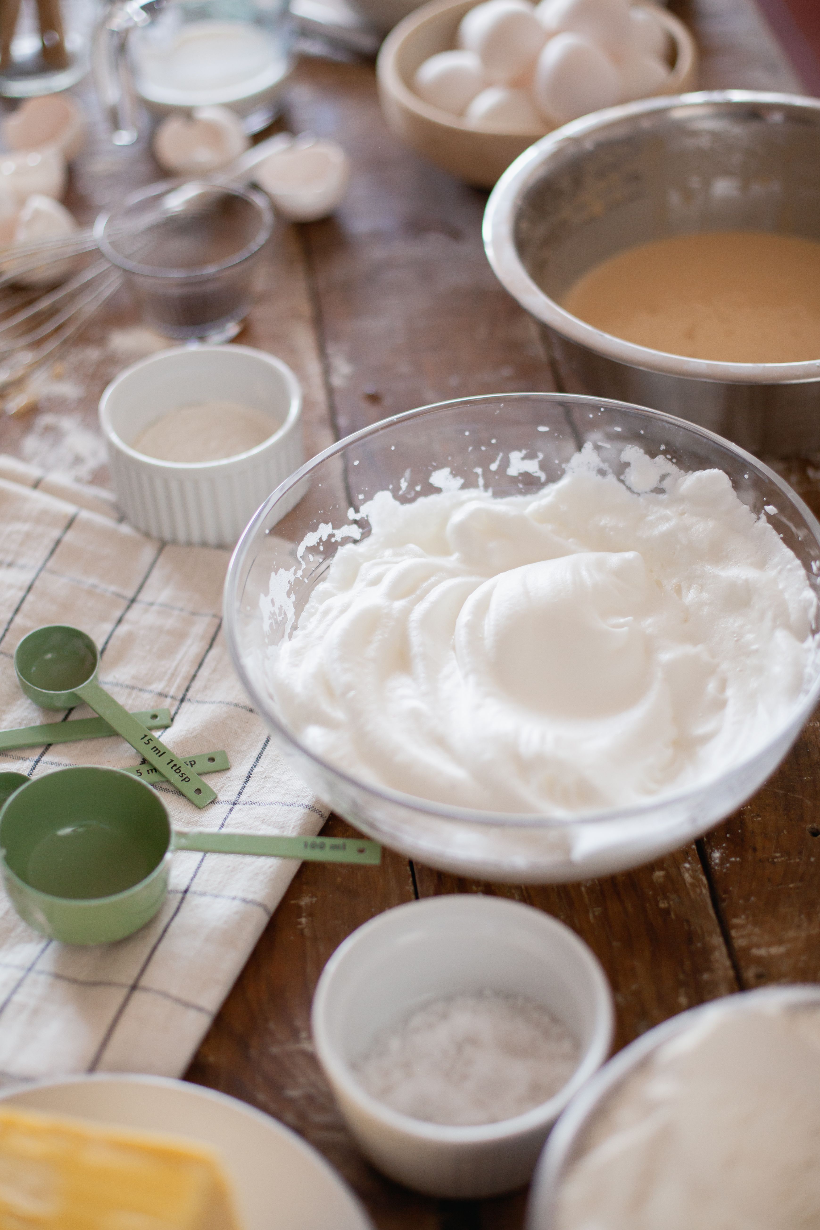 A detailed view of baking ingredients and tools on a kitchen table, ready for cooking.