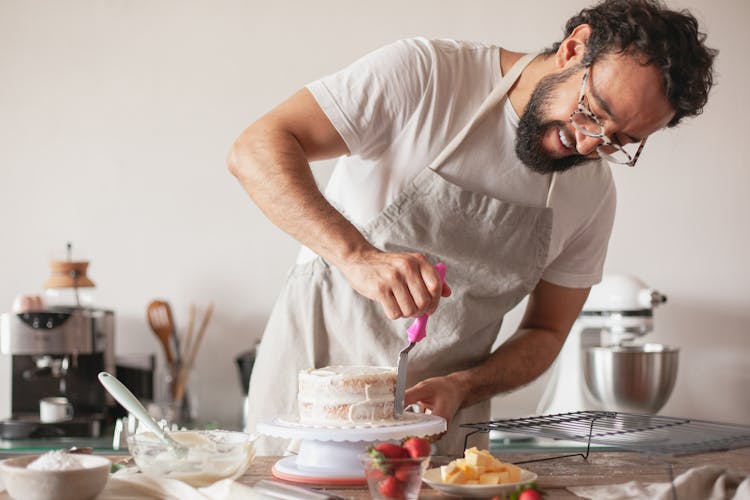 A Baker Making A Cake In A Kitchen