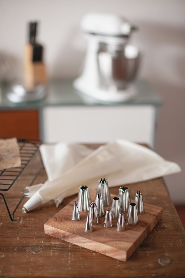 A Variety Of Piping Bag Tips On A Kitchen Counter Top