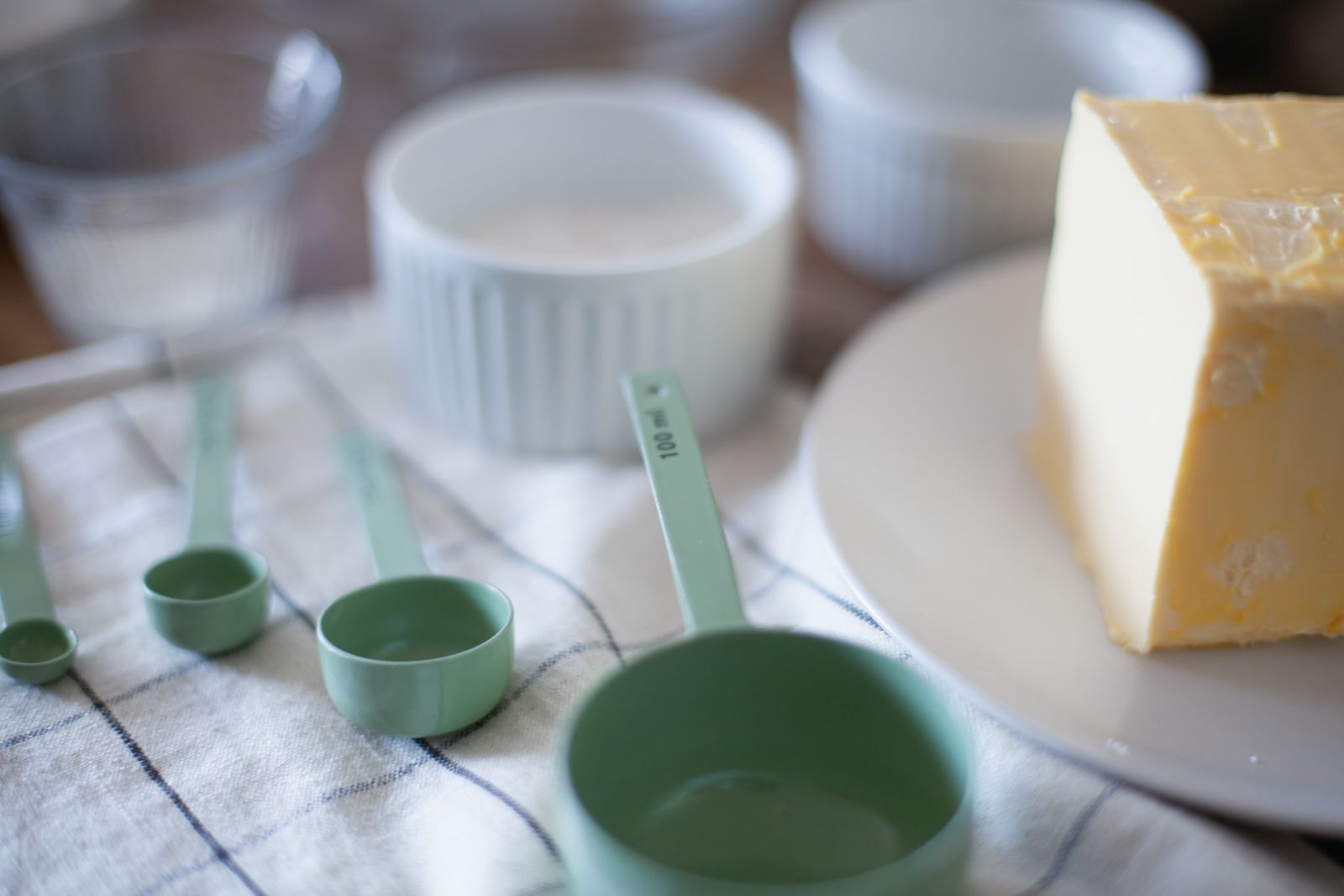 Butter and measuring cups arranged for a baking recipe