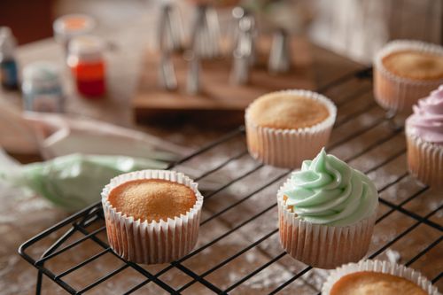 Free Homemade cupcakes cooling with colorful frosting, perfect for dessert lovers. Stock Photo