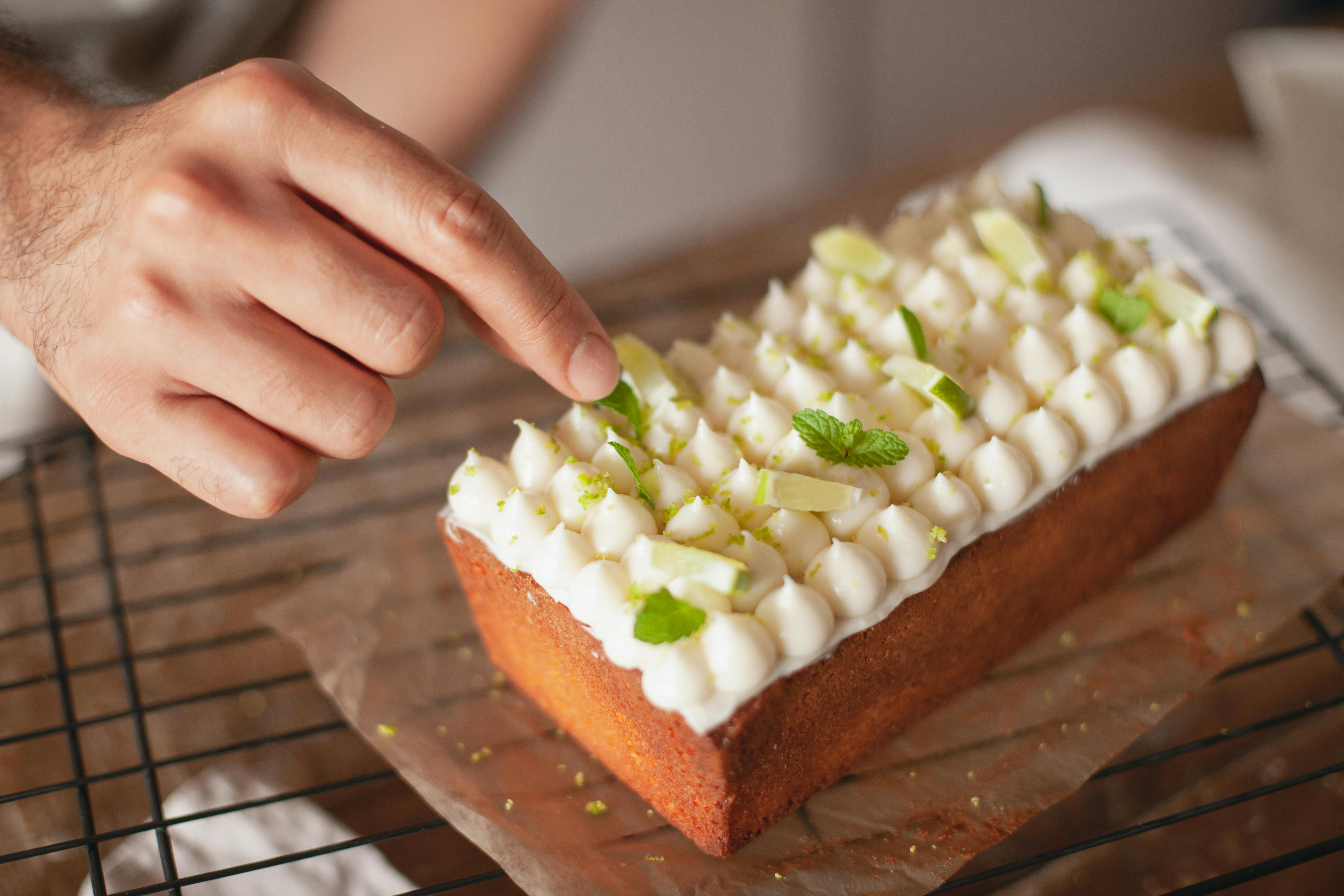 cake with white frosting and mint leaves