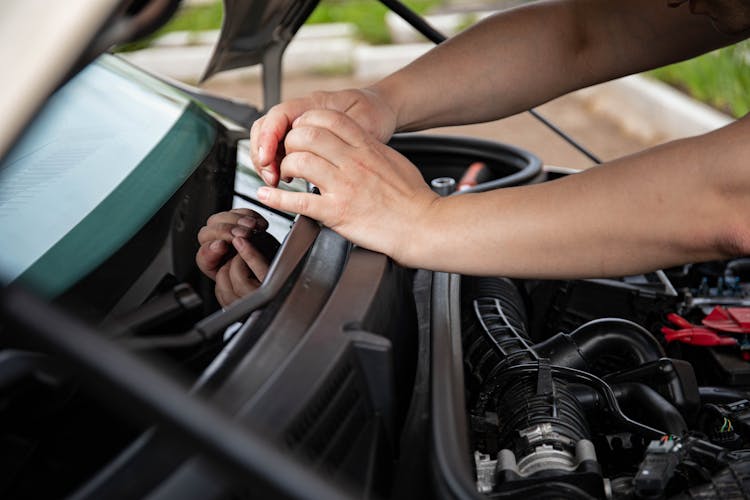 A Person's Hands On A Car Wiper