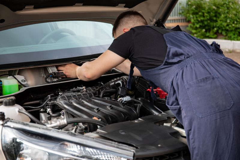 Technician reviewing alignment readout on a computer screen in a service bay