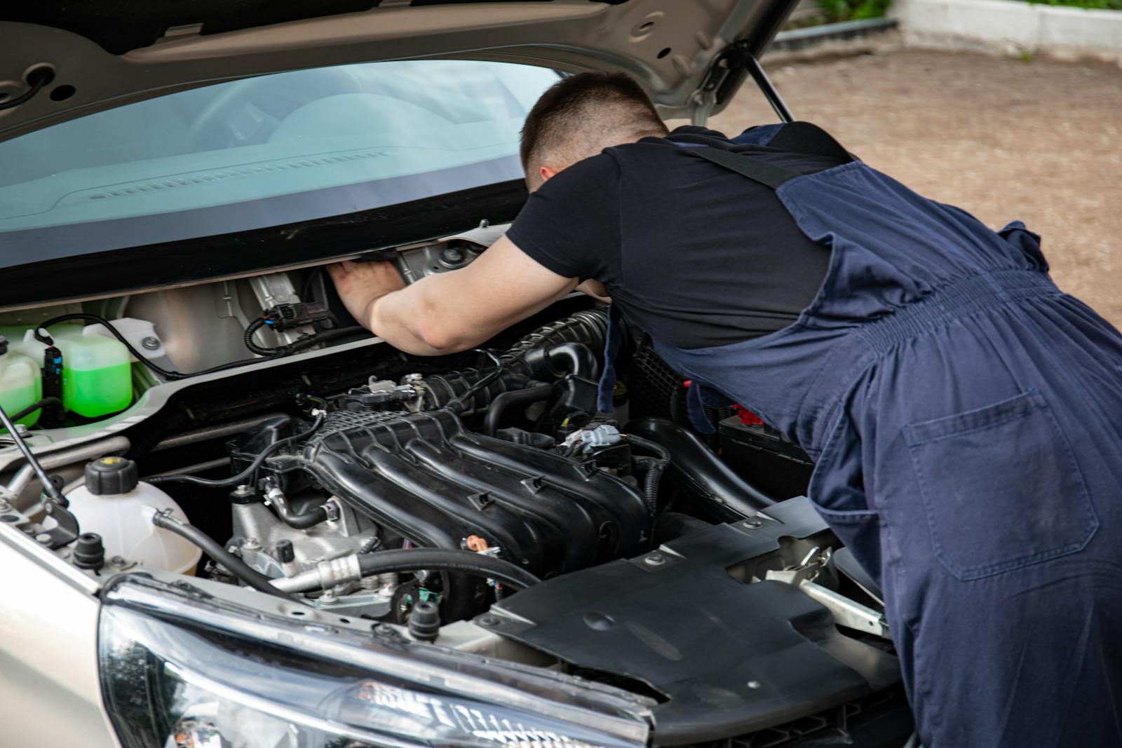 Professional mechanic working on vehicle engine