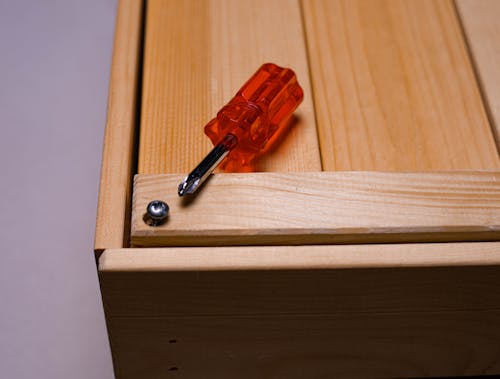 Wooden Box with Red and Silver Screwdriver 