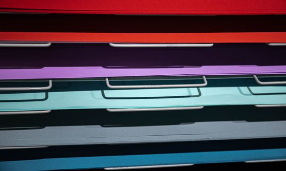 Stacked colourful papers in an art studio — photo by Sergey Meshkov on Pexels