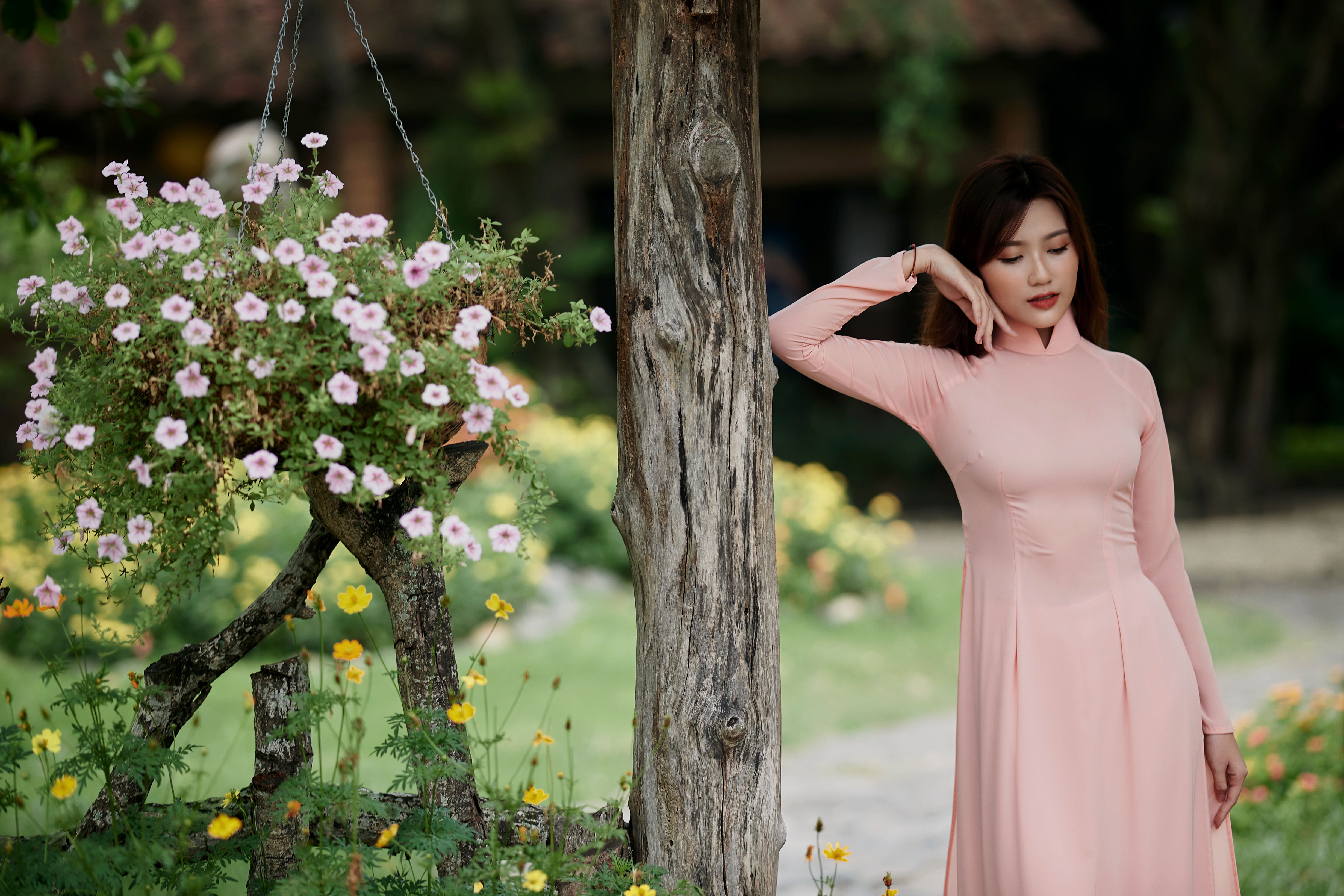 Woman in Pink Dress Standing Beside Tree · Free Stock Photo